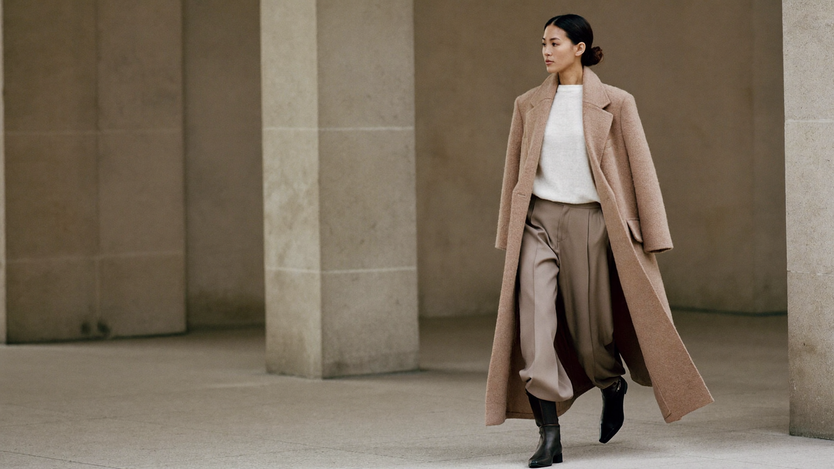 Woman in a stone wool wrap coat in a stone courtyard, Vittorio Delsari Autumn/Winter 2026