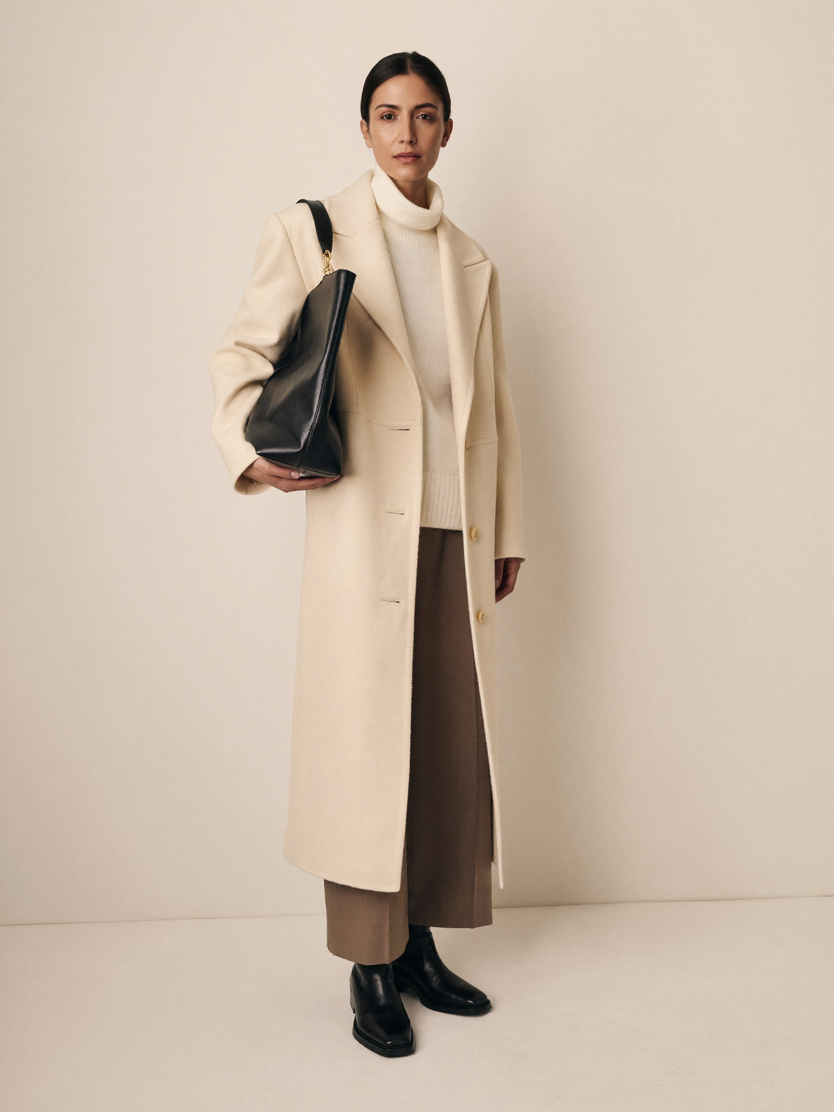 Cream wool coat outfit with taupe trousers and black boots